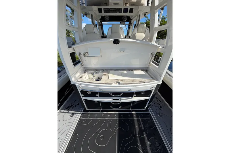 Slide: The Image of 2021 Solace 345CC boat interior with open storage compartments and seating. - 36