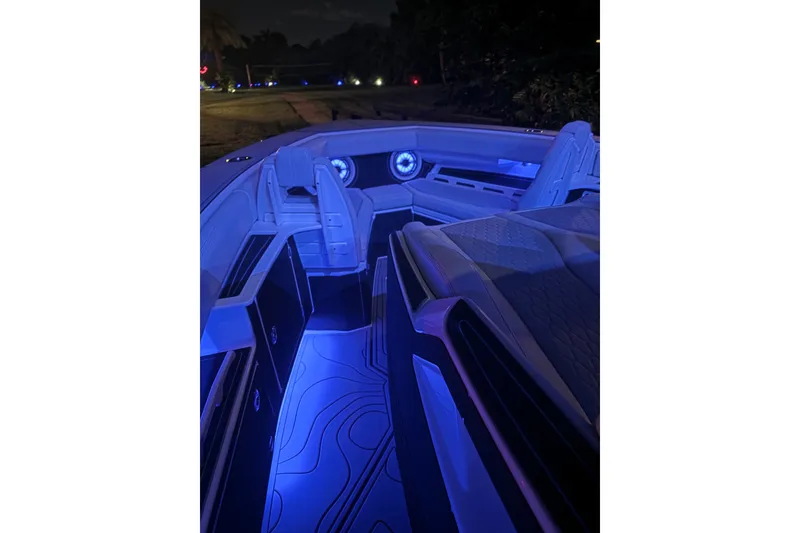 Slide: The Image of 2021 Solace 345CC boat interior with blue LED lighting at night. - 30