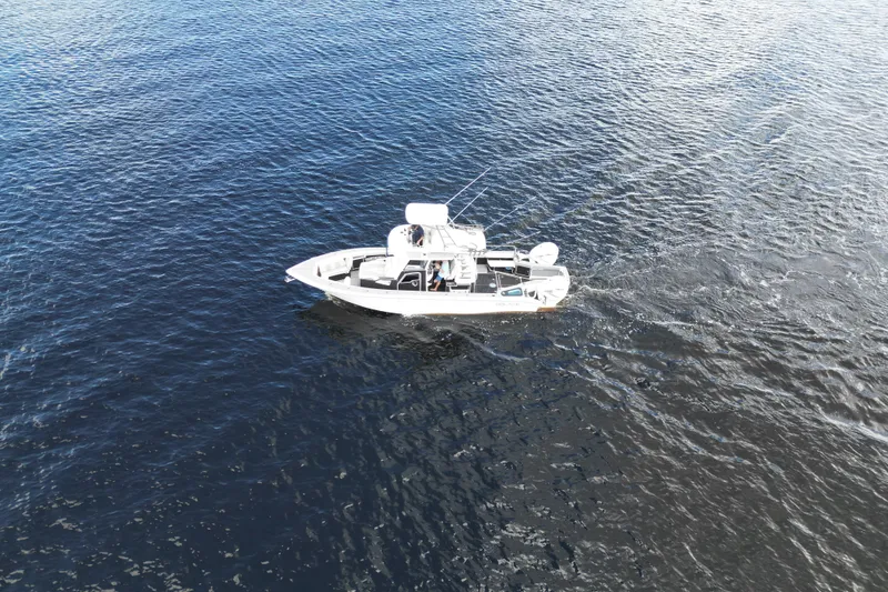 Slide: The Image of Aerial view of 2021 Solace 345CC boat cruising on open water. - 13
