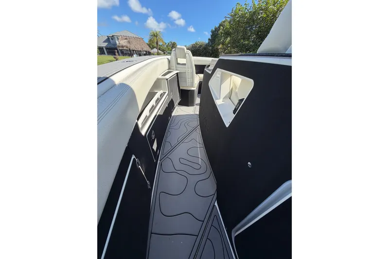 Slide: The Image of 2021 Solace 345CC boat interior with sleek design and modern features under a clear blue sky. - 28