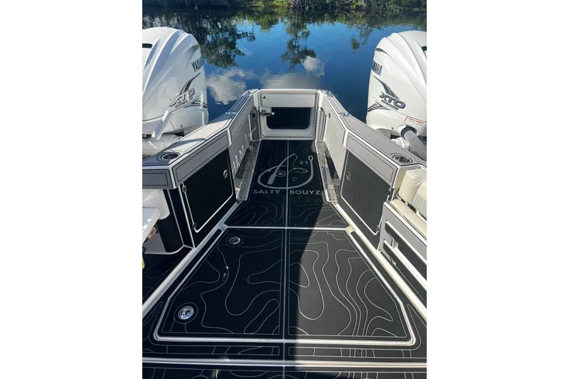 Slide: The Image of 2021 Solace 345CC boat deck with Yamaha engines, featuring sleek black flooring design. - 37