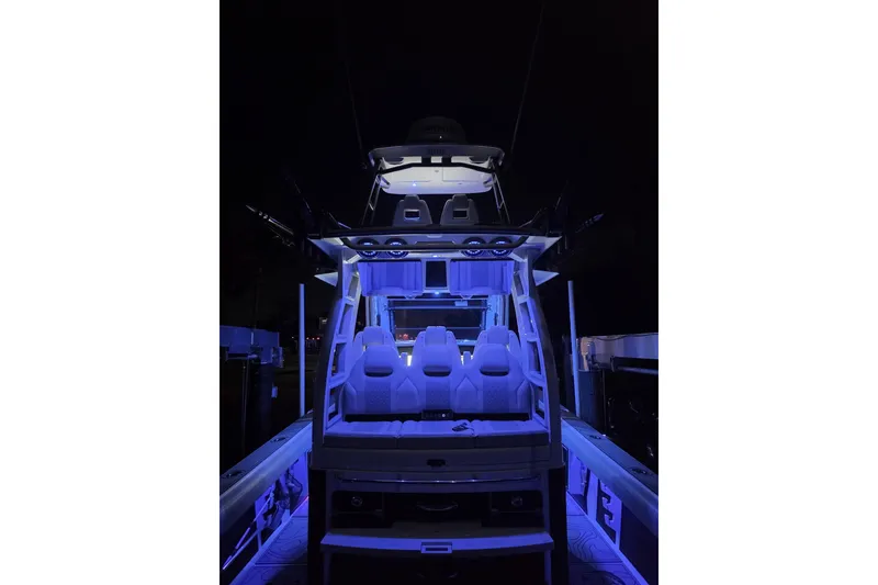 Slide: The Image of 2021 Solace 345CC boat illuminated at night with blue LED lights. - 39