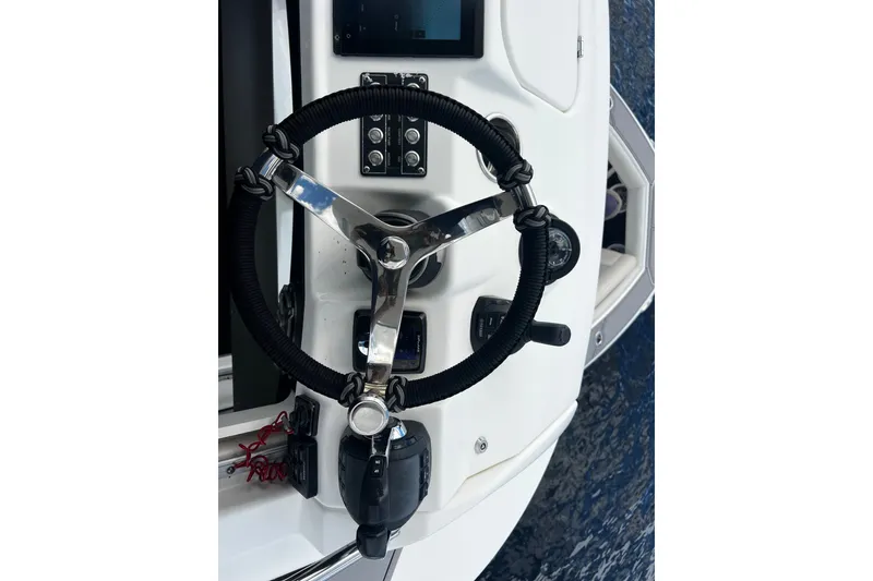 Slide: The Image of Steering wheel of a 2021 Solace 345CC boat, featuring modern controls and sleek design. - 22