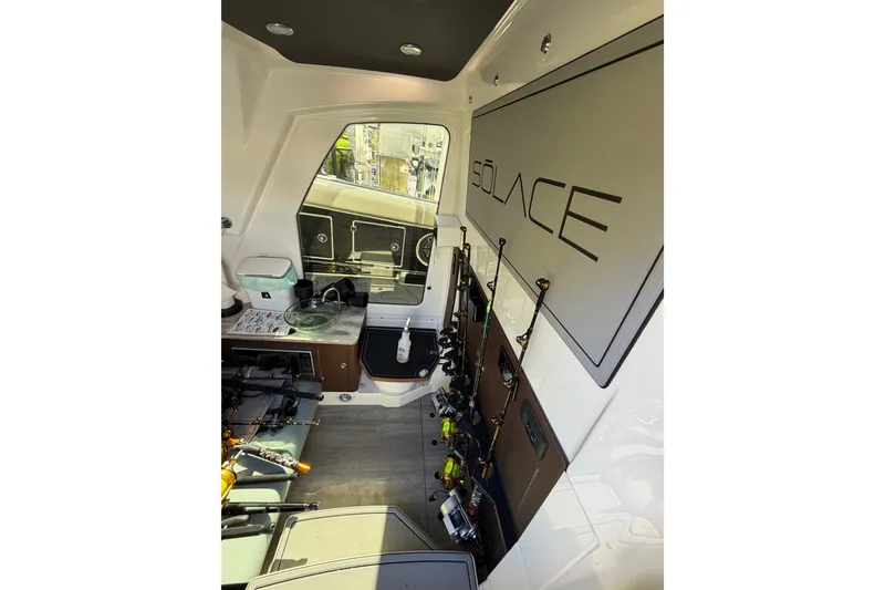 Slide: The Image of Interior of 2021 Solace 345CC boat with fishing rods and equipment storage. - 30