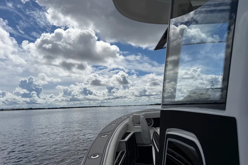 Slide: The Image of 2021 Solace 345CC boat on calm water under a cloudy sky. - 15