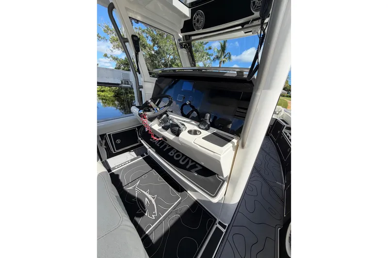 Slide: The Image of 2021 Solace 345CC boat interior with modern dashboard and sleek design. - 23