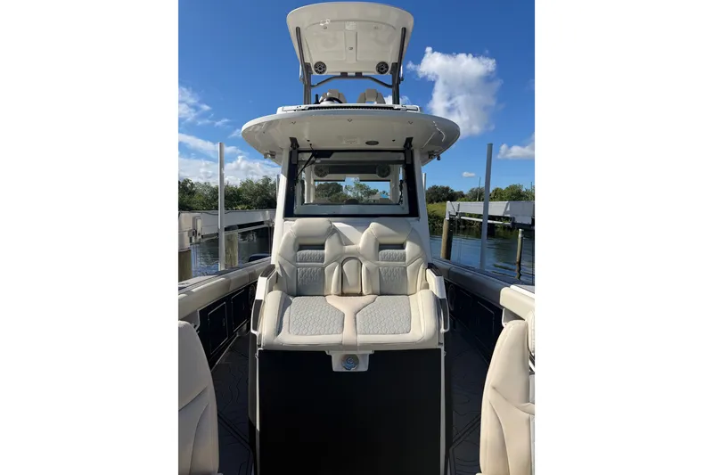 Slide: The Image of 2021 Solace 345CC boat interior with plush seating and clear blue sky background. - 18