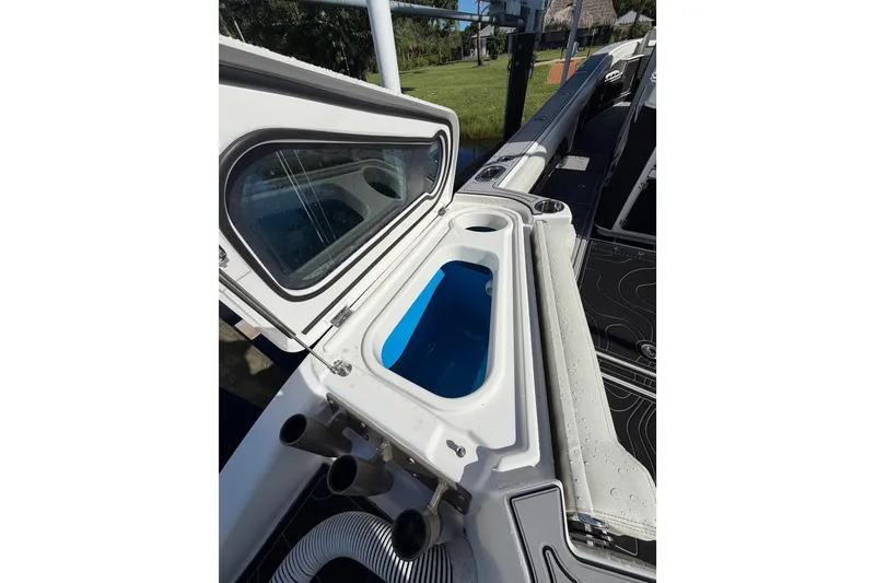 Slide: The Image of 2021 Solace 345CC boat with open storage compartment and sleek design. - 42