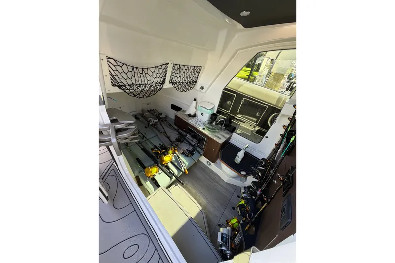 Slide: The Image of Interior of 2021 Solace 345CC boat with fishing gear and storage. - 29