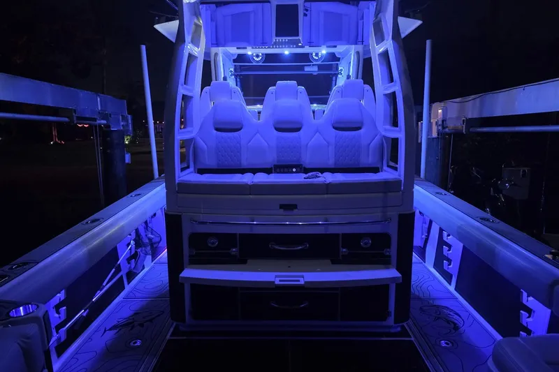 Slide: The Image of The image shows the cockpit of a 2021 Solace 345CC boat with blue lighting. - 40