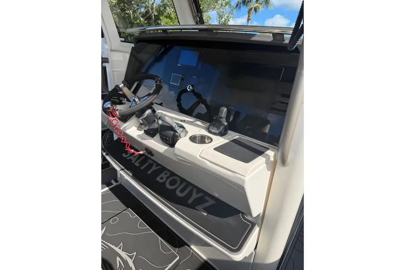 Slide: The Image of 2021 Solace 345CC boat dashboard with steering wheel and controls. - 24