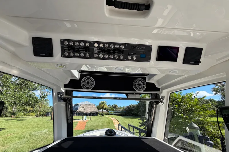 Slide: The Image of Interior view of 2021 Solace 345CC boat dashboard with control panel and speakers. - 25