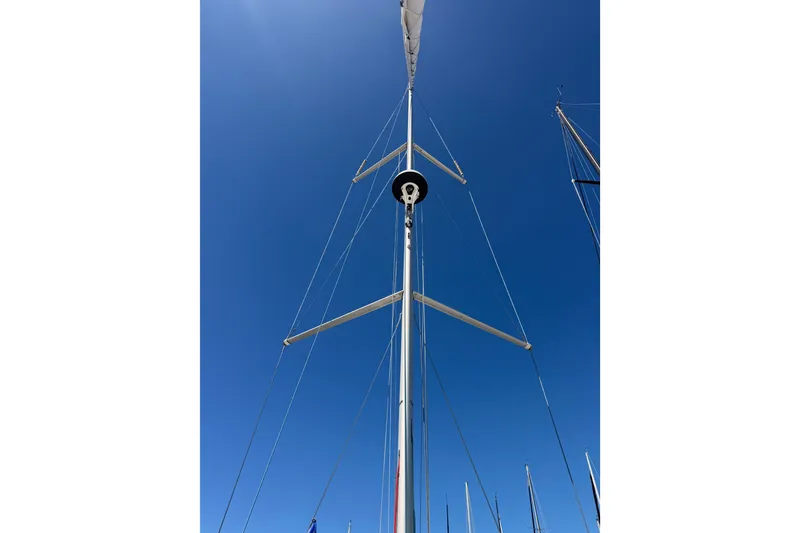Slide: The Image of Mast of 2024 Jeanneau Sun Odyssey 380 sailboat against clear blue sky. - 19