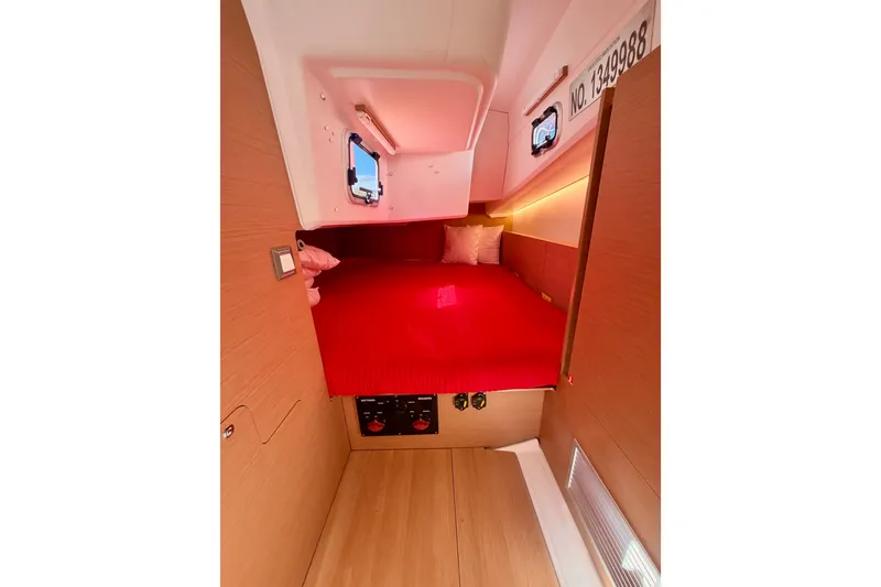Slide: The Image of Cozy cabin interior of 2024 Jeanneau Sun Odyssey 380 with red bedding and modern design. - 48