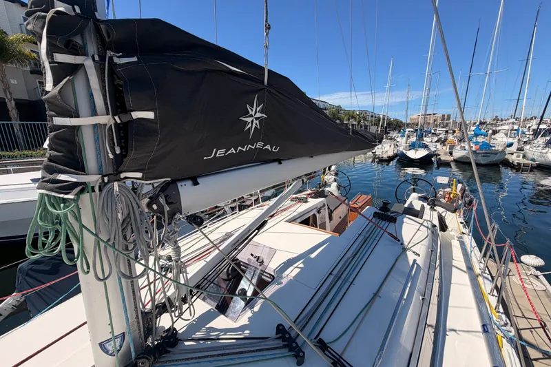Slide: The Image of 2024 Jeanneau Sun Odyssey 380 sailboat docked in marina, showcasing deck and rigging. - 21