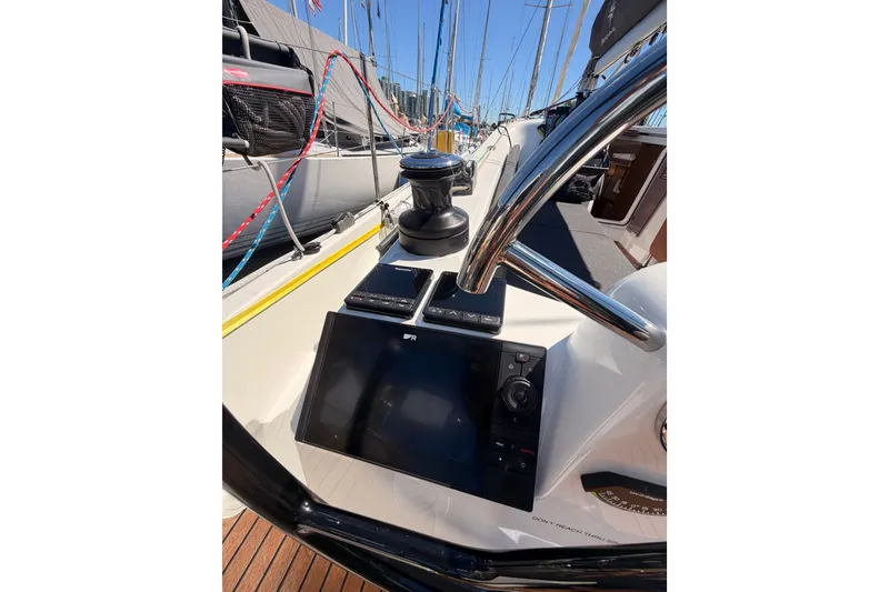 Slide: The Image of 2024 Jeanneau Sun Odyssey 380 cockpit with navigation equipment and steering wheel. - 32