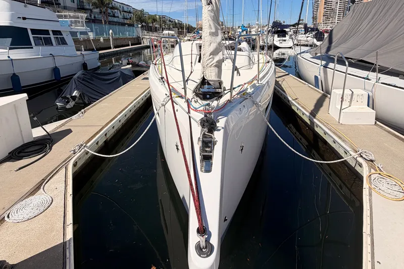 Slide: The Image of 2024 Jeanneau Sun Odyssey 380 docked at a marina, showcasing sleek design and modern features. - 4