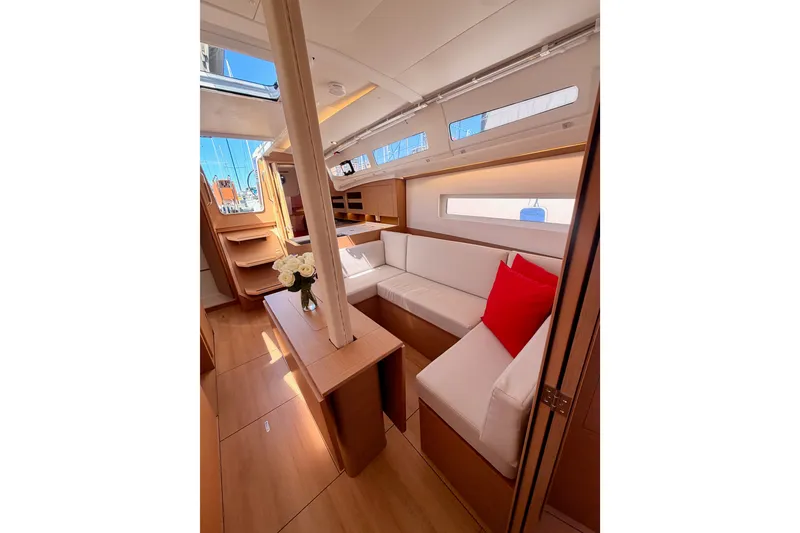 Slide: The Image of Interior of 2024 Jeanneau Sun Odyssey 380 yacht, featuring modern seating and elegant wood finishes. - 72