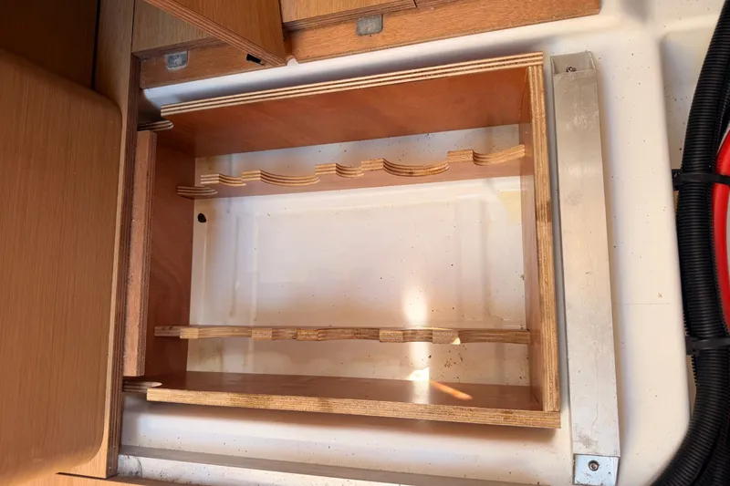 Slide: The Image of Wooden storage compartment in 2024 Jeanneau Sun Odyssey 380 sailboat interior. - 82