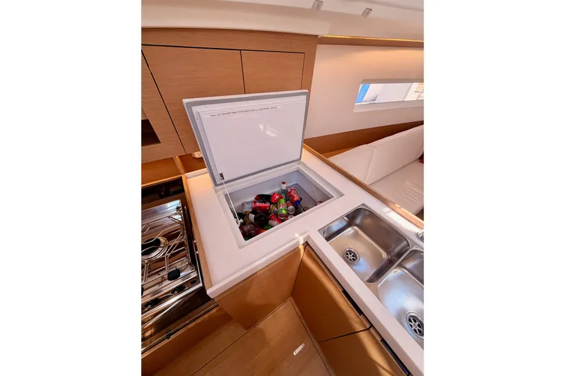 Slide: The Image of Modern kitchen in 2024 Jeanneau Sun Odyssey 380 yacht with fridge and dual sinks. - 45
