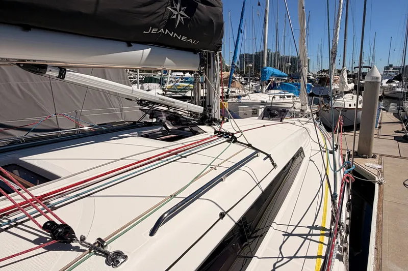 Slide: The Image of 2024 Jeanneau Sun Odyssey 380 sailboat docked at marina, showcasing deck and rigging. - 12