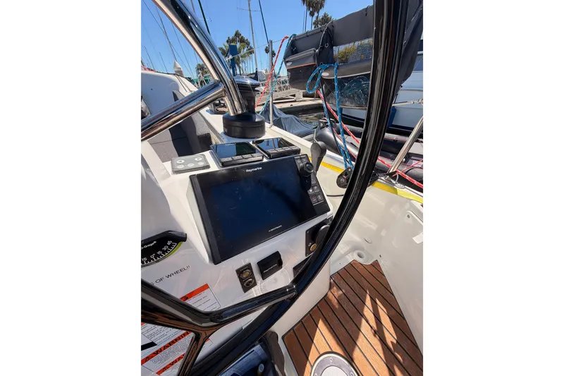 Slide: The Image of Cockpit of 2024 Jeanneau Sun Odyssey 380 sailboat with navigation equipment and steering wheel. - 35