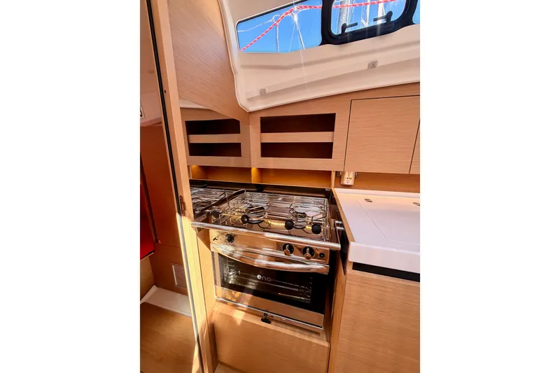 Slide: The Image of Modern kitchen interior of 2024 Jeanneau Sun Odyssey 380 yacht with stove and cabinetry. - 46