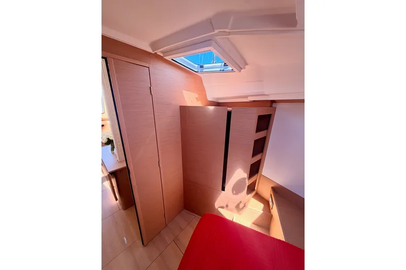 Slide: The Image of Interior of 2024 Jeanneau Sun Odyssey 380 yacht, featuring modern wood paneling and skylight. - 69