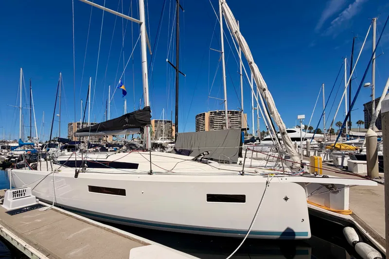 Slide: The Image of 2024 Jeanneau Sun Odyssey 380 sailboat docked at marina under clear blue sky. - 3