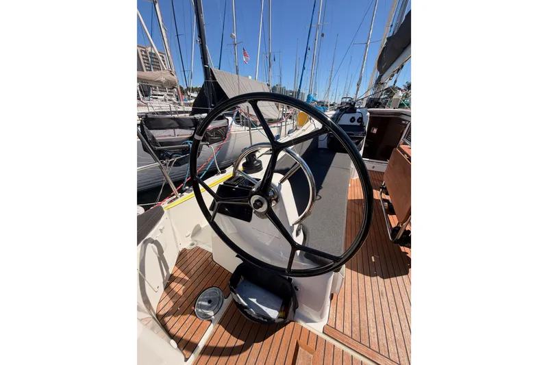 Slide: The Image of Steering wheel of 2024 Jeanneau Sun Odyssey 380 sailboat, docked at marina. - 31