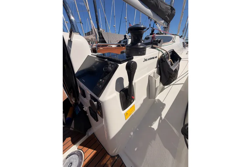Slide: The Image of 2024 Jeanneau Sun Odyssey 380 cockpit with navigation controls and winch, showcasing sleek design. - 36