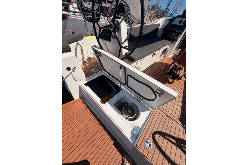 Slide: The Image of Cockpit view of 2024 Jeanneau Sun Odyssey 380 sailboat with open storage compartment. - 29