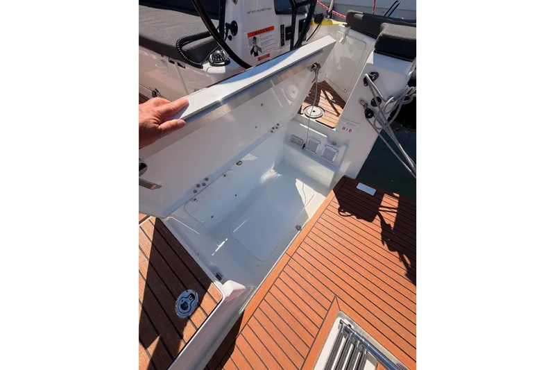 Slide: The Image of 2024 Jeanneau Sun Odyssey 380 cockpit storage compartment with teak flooring. - 27