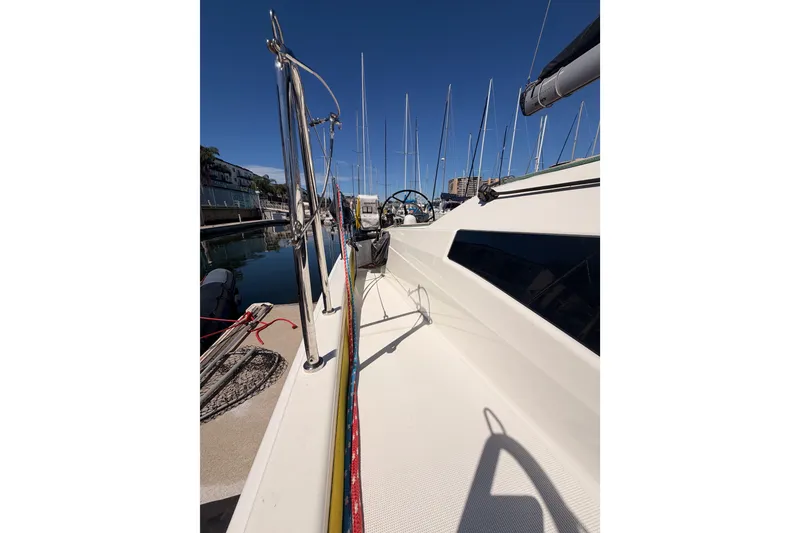 Slide: The Image of 2024 Jeanneau Sun Odyssey 380 sailboat docked in marina under clear blue sky. - 10