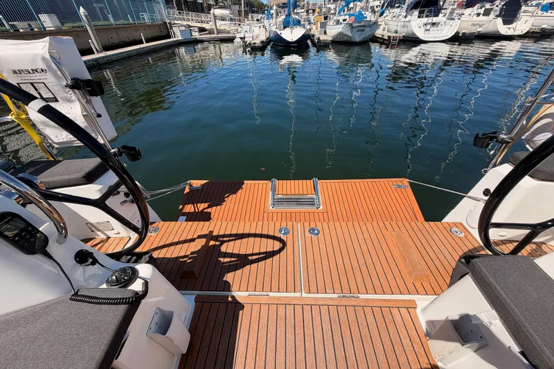 Slide: The Image of 2024 Jeanneau Sun Odyssey 380 yacht deck with marina view, featuring sleek design and modern amenities. - 26