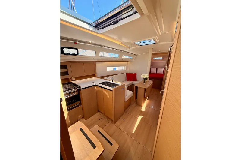 Slide: The Image of Interior of 2024 Jeanneau Sun Odyssey 380 yacht, featuring modern kitchen and cozy seating area. - 56