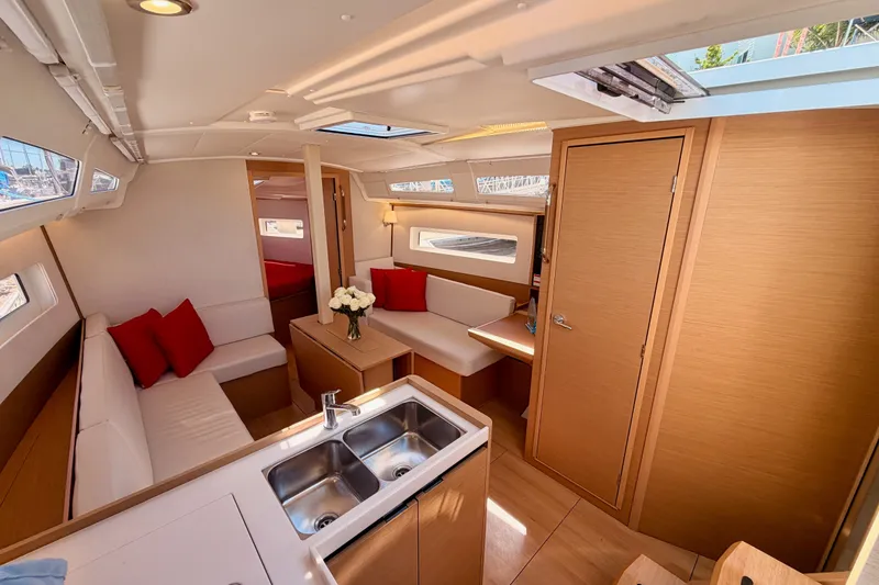 Slide: The Image of Luxurious interior of 2024 Jeanneau Sun Odyssey 380 sailboat with modern design and cozy seating. - 51