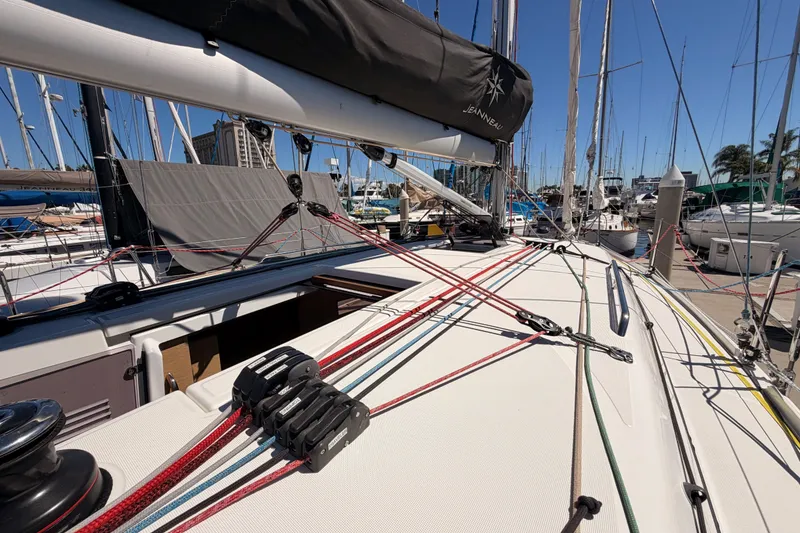 Slide: The Image of 2024 Jeanneau Sun Odyssey 380 sailboat deck with rigging in a marina setting. - 13