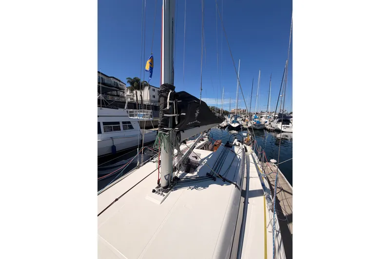 Slide: The Image of 2024 Jeanneau Sun Odyssey 380 sailboat docked in a marina under clear blue skies. - 20
