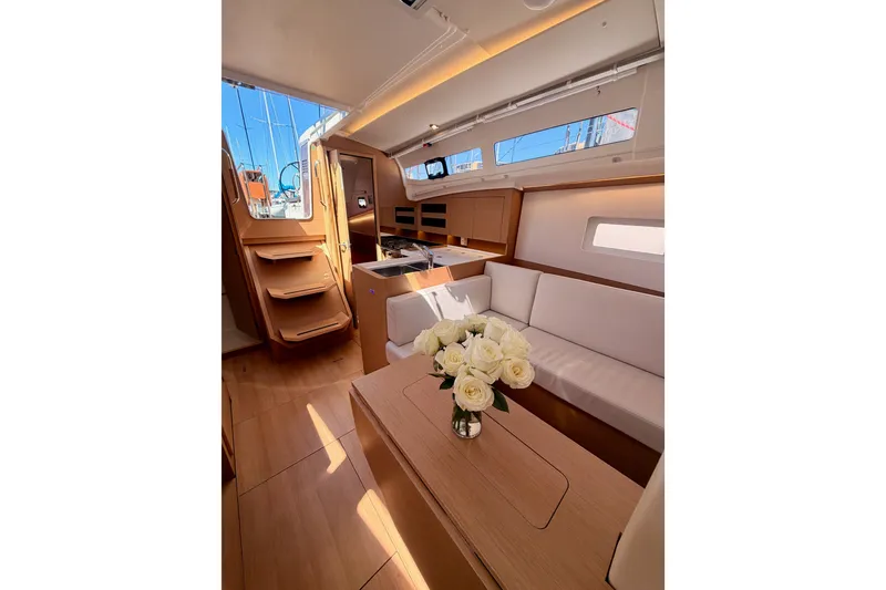 Slide: The Image of Interior of 2024 Jeanneau Sun Odyssey 380 yacht, featuring elegant seating and wooden finishes. - 75