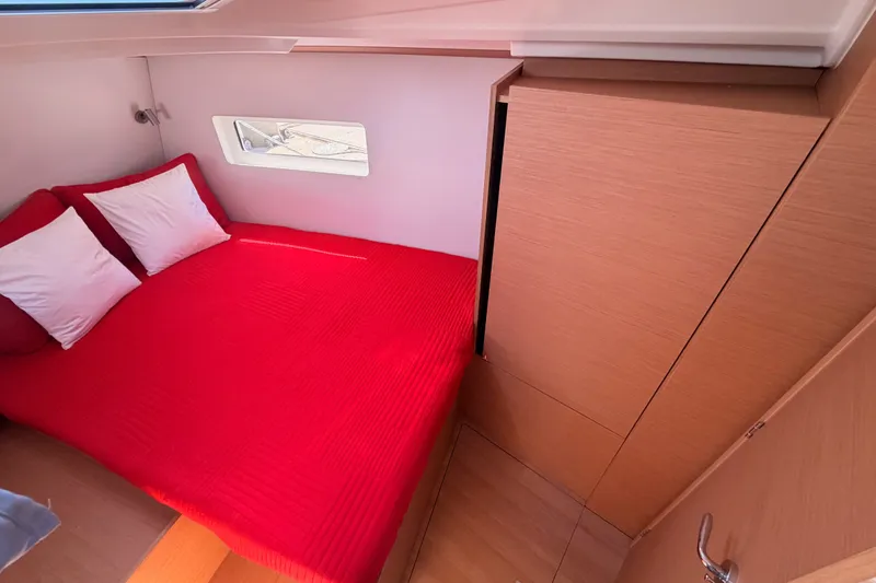 Slide: The Image of Cozy cabin interior of 2024 Jeanneau Sun Odyssey 380 with red bedding. - 68
