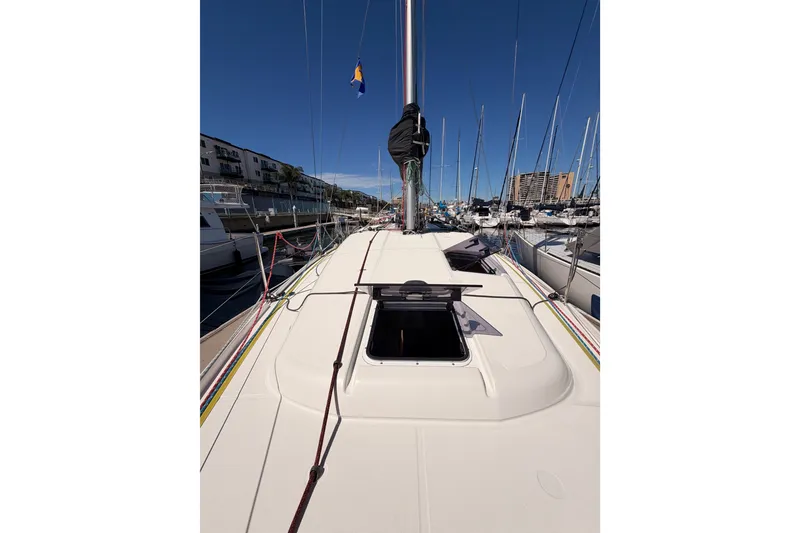Slide: The Image of 2024 Jeanneau Sun Odyssey 380 sailboat docked in marina, showcasing deck and mast. - 18