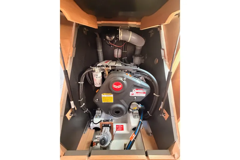 Slide: The Image of Engine compartment of 2024 Jeanneau Sun Odyssey 380 sailboat, showcasing mechanical components. - 77