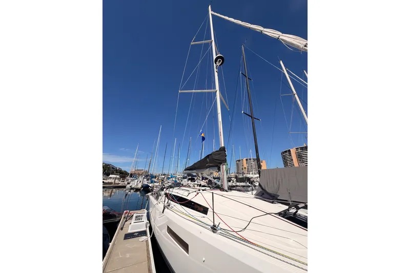 Slide: The Image of 2024 Jeanneau Sun Odyssey 380 sailboat docked at marina under clear blue sky. - 7