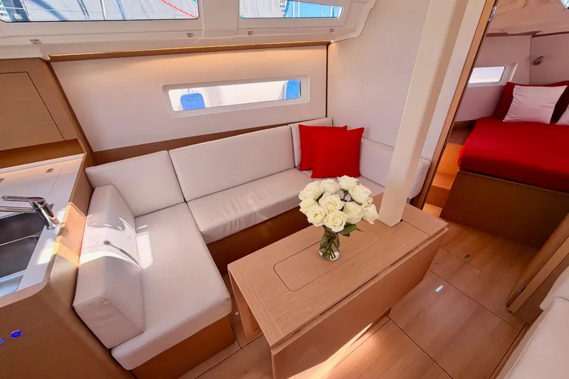 Slide: The Image of Luxurious interior of 2024 Jeanneau Sun Odyssey 380 yacht with elegant seating and decor. - 63