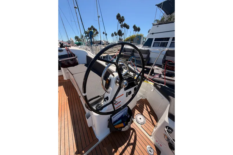 Slide: The Image of 2024 Jeanneau Sun Odyssey 380 cockpit with steering wheel and teak deck. - 33