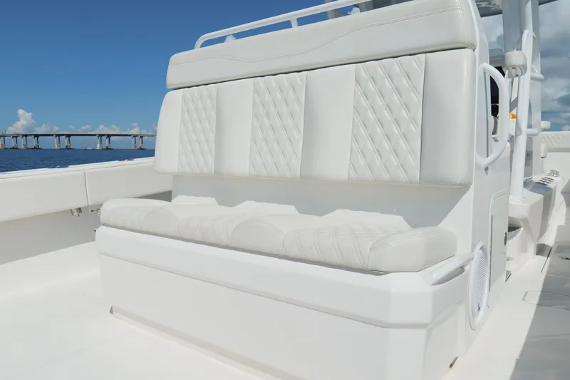 Slide: The Image of Luxurious seating on 2022 Invincible 33 Catamaran, with ocean and bridge in background. - 26