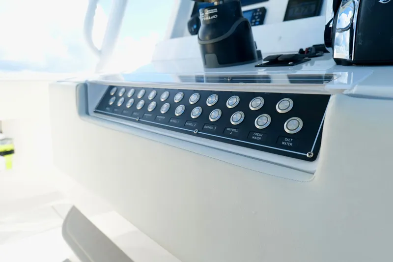Slide: The Image of Control panel of 2022 Invincible 33 Catamaran, featuring multiple buttons and sleek design. - 15