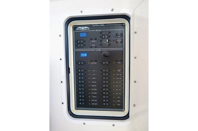 Slide: The Image of Control panel of 2022 Invincible 33 Catamaran, featuring AC and DC switches. - 47