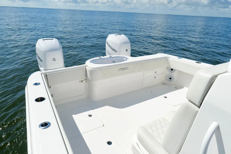 Slide: The Image of 2022 Invincible 33 Catamaran boat deck with twin engines on open water. - 21